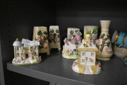 Two Coalport ceramic model houses with four spill vases.