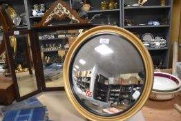 A Victorian tryptich dressing table mirror with a similar convex butlers mirror.
