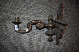 An early 20th century heavy cast brass wall mounted light fixture.