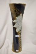 A large Japanese porcelain vase of slender trumpet form decorated with exotic flowers with