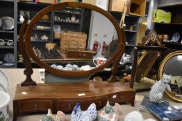 A large sized Victorian toilet mirror having mahogany frame with carved supports and formed feet.