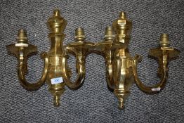A pair of two branch wall mounted brass light fixtures.