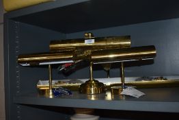 Three modern brass cased office or wall mounted lights.