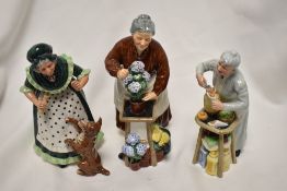 Three Royal Doulton figure studies Flora HN2349, Old Mother Hubbard HN2314 and A Pennys Worth
