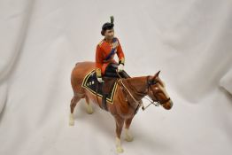 A Beswick figure study of the Queen Elizabeth the second on Imperial Trooping colour Hn1546.