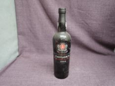 A bottle of 1994 Taylors Late Bottled Vintage Port, 20% vol 75cl, been laid down in a cellar