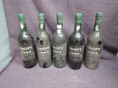 Five bottles of Croft 1963 Vintage Port, no strength or capacity stated, been laid down in a cellar,