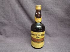 A bottle of Cream of the Barley Special Reserve Rare Old Scotch Whisky, blended and bottled in