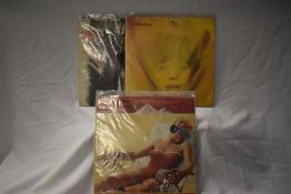 Three Rolling Stones albums including Sticky Fingers Warhol zip sleave.