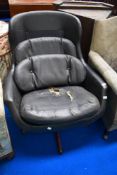 A mid century black leather egg chair.
