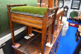 An early 20th century mahogany piano stool with storage.