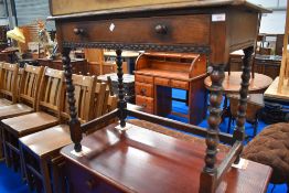 A Victorian oak side table with drawer and carved details.