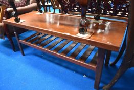 A mid century teak coffee table with under shelf.