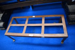 An antique long copper framed fire side trivet.