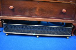 A Victorian fire grill with fret work sides.