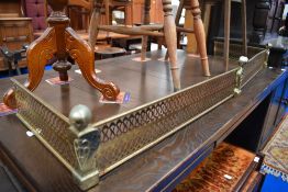A vintage pierced brass fire guard.