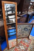 A cheval mirror frame with a Edwardian embroidery fire screen.