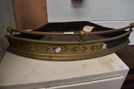 A vintage pierced brass fire fender.