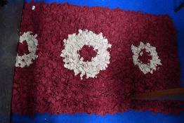 A pegged rag rug, in burgundy and cream tones, approx. 150 x 75cm