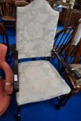 A traditional wood frame armchair having scroll arms and upholstered seat and back