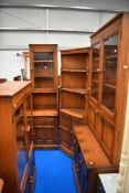A suite of mid century Ercol furniture including two glazed display cases, side board, corner