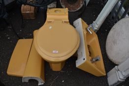 A mid century mustard yellow bathroom set.