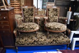 An Edwardian mahogany three piece suite with inlaid decoration and later velvour upholstery