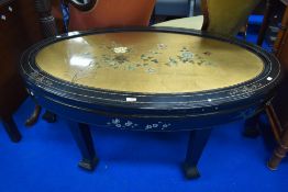 A Japanese lacquer work coffee table with foliage and bird design.