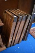 A stack of four vintage bakers bread trays.