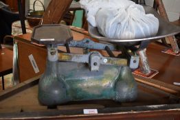 A set of vintage kitchen balance scales with weights.