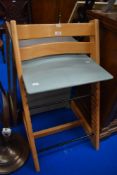 An adjustable baby seat made in Beech wood.