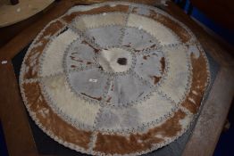 A circular animal hide throw.
