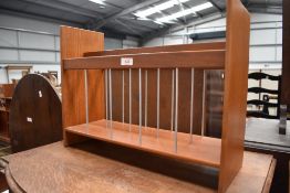 A mid century teak magazine rack.