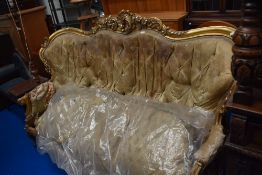 An 19th century high Victorian button back sofa having carved foliate gilt wood frame in good