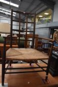 An early 20th century rush seated chair with lattice work back.