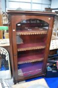 A Victorian display case with velvet interior and glazed door.