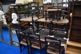 An early 20th century dining table and set of six chair plus foot stool ebonised with rush seats.