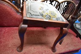 An early 20th century piano stool with upholstered top.