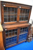 An Edwardian oak book case having leaded light doors in good condition.