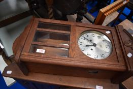An early 20th Century oak cased wall clock, silvered dial stamped Haller A.G.