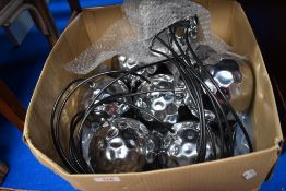 A modern drop ceiling light fixture with chrome shades.