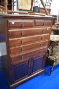 An early 20th Century mahogany cabinet having two over four drawers and cupboard to base, width