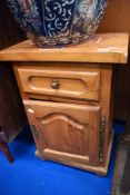 A modern pine bedside cabinet