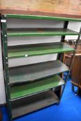 A set of industrial style shelves painted green.