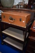 A vintage tea trolley with suitcase.