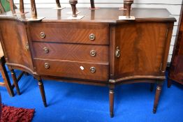 A reproduction Regency sideboard (strongbow) having shaped front with central three drawers