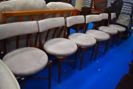 A set of six mid century teak framed chairs.