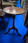 An antique wine table on tripod base with oak frame.