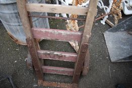 A vintage wooden framed sack truck.