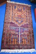 A Persian style prayer mat with imagery of religious buildings.